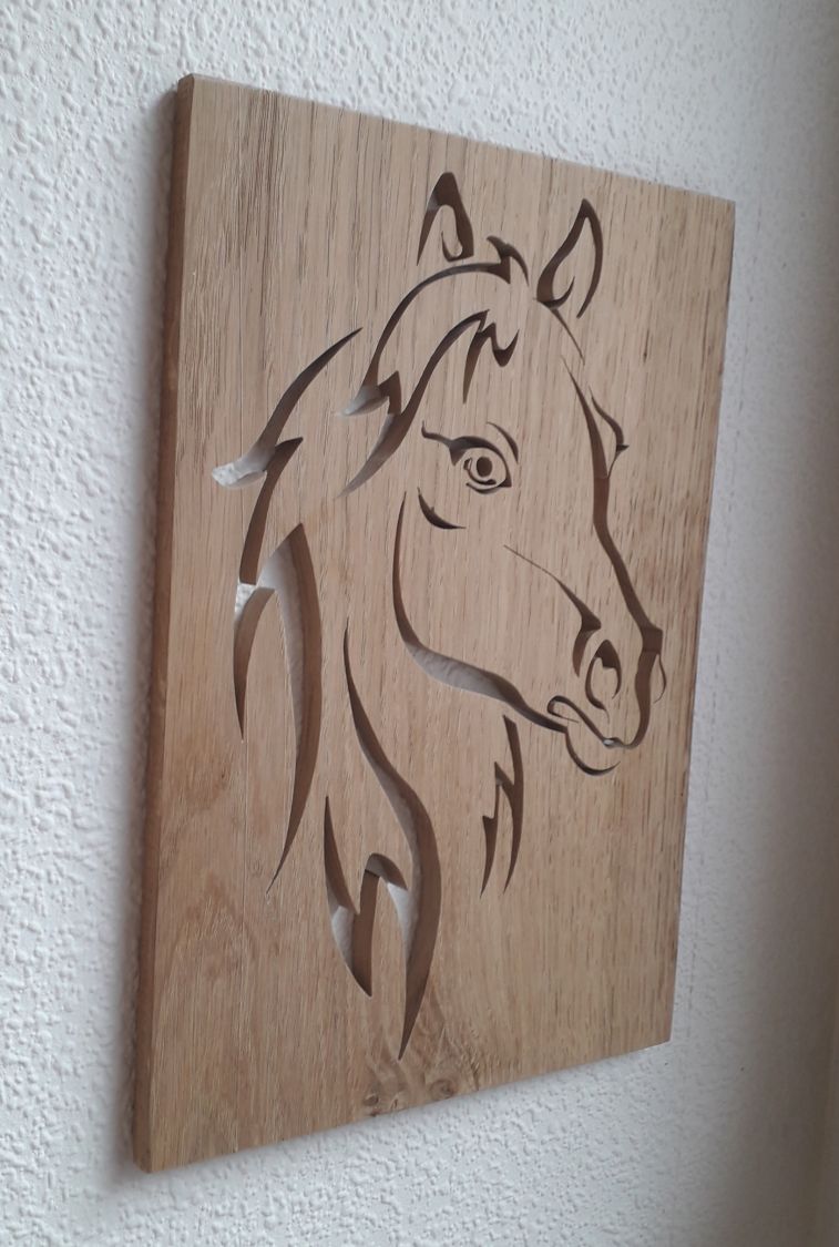 Tête de cheval stylisée, découpée dans un panneau de chêne
