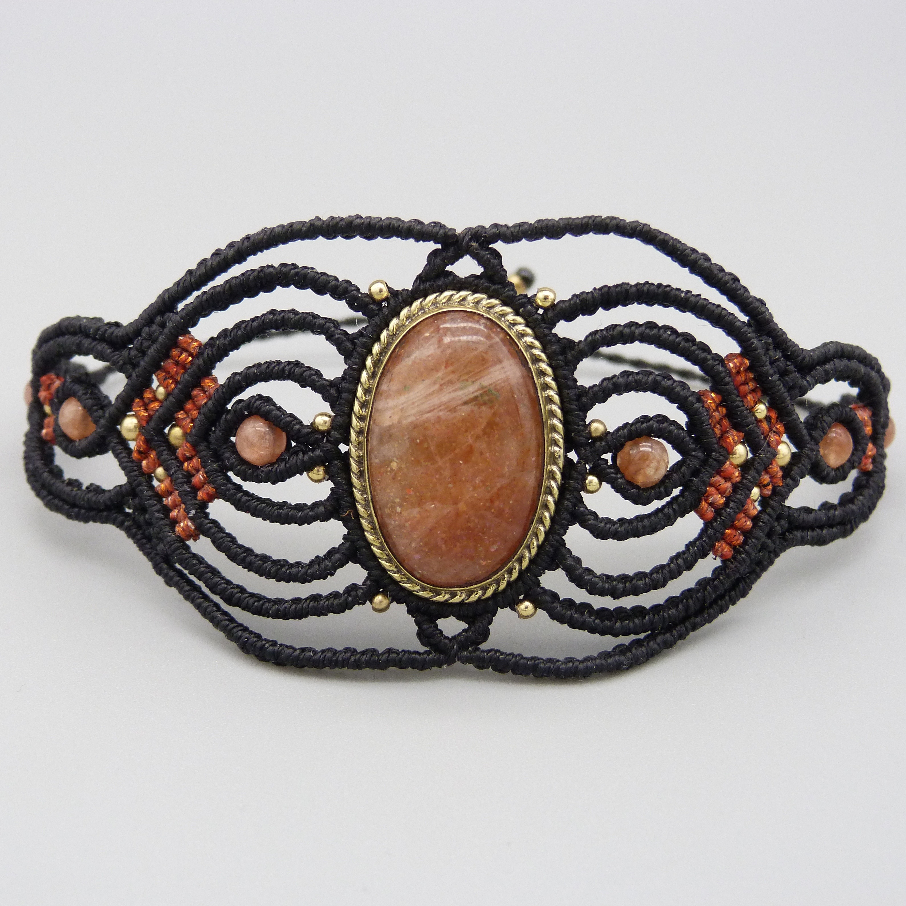 Manchette noire en micro-macram&eacute; avec une pierre de soleil