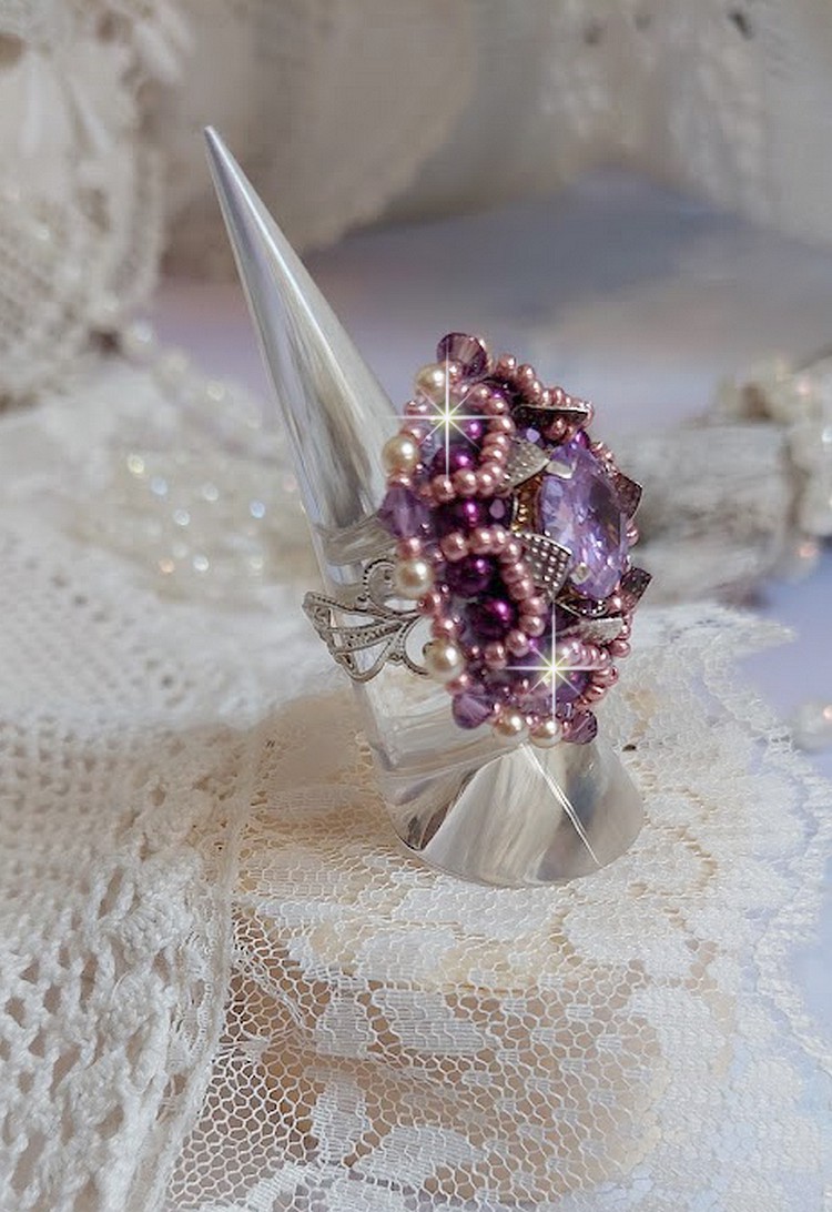 Bague Chinese Purple Stone brodée avec un cabochon rond en cristal Violet à laquelle s'ajoute une grande coupelle filigranée, facettes, perles rondes nacrées et rocailles sur un support bague Argentée