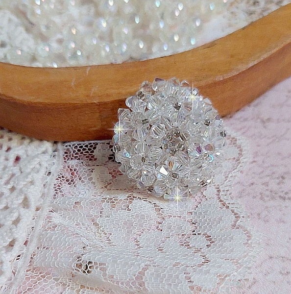  Bague Flocons mont&eacute;e avec des toupies en Cristal de Swarovski et des facettes en Verre de Boh&egrave;me o&ugrave; la couleur Blanche domine. Les perles s&rsquo;entrelacent avec les rocailles Argent&eacute;es comme des flocons 