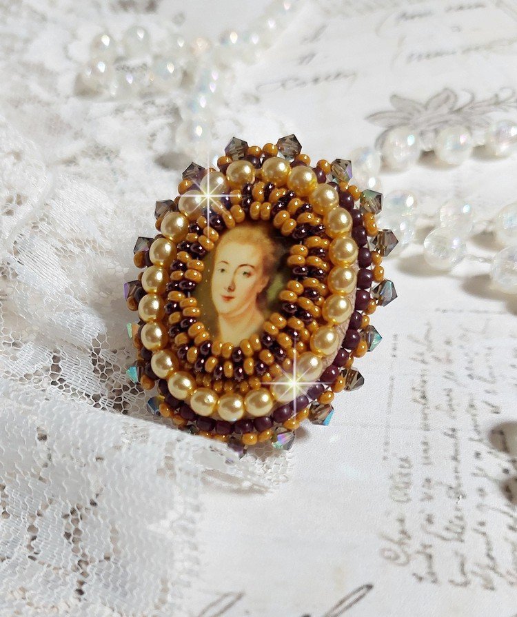 Bague Madame de Pompadour brodée avec un cabochon représentant une femme à laquelle s'ajoute des toupies, perles rondes nacrées, rocailles aux couleurs Jaune et Marron sur bague Bronze en laiton