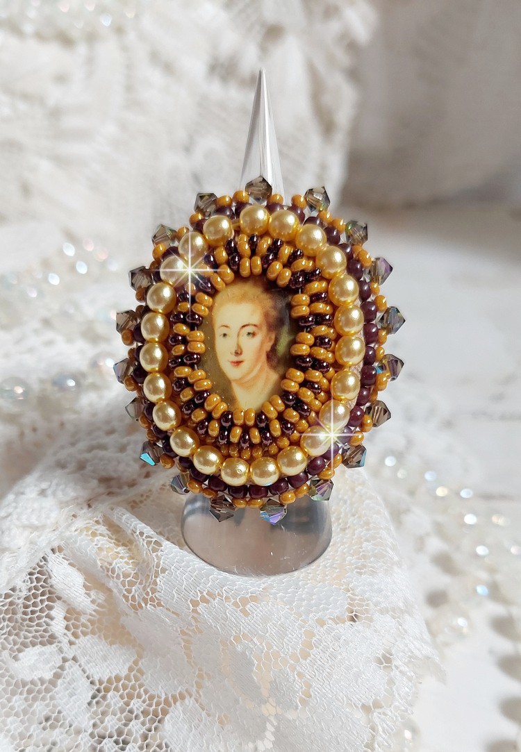 Bague Madame de Pompadour brodée avec un cabochon représentant une femme à laquelle s'ajoute des toupies, perles rondes nacrées, rocailles aux couleurs Jaune et Marron sur bague Bronze en laiton