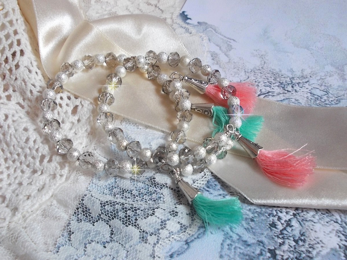 Bracelets Cristalline Eclat avec doubles bracelets aux perles Stardust Argentées effet pailleté, perles rondes facettées en verre et pompons couleur Rose et Menthe pour un style contemporain