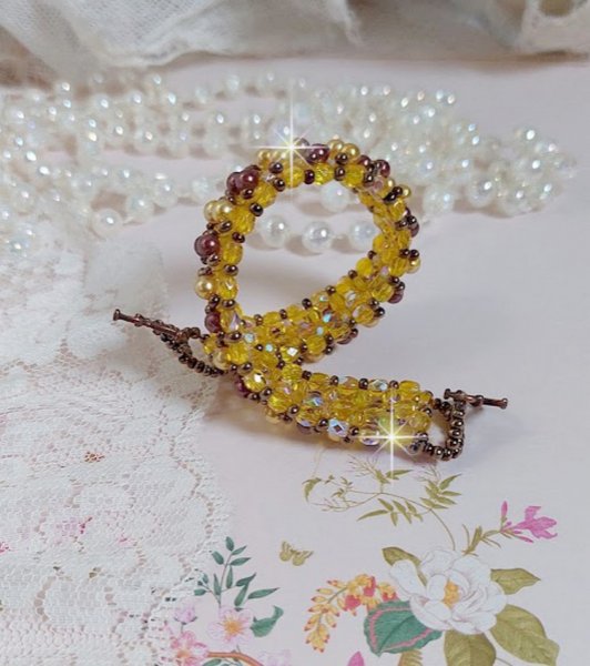 Bracelet Soleil mont&eacute; avec des facettes en verre de boh&egrave;me aux couleurs Topaze AB &agrave; laquelle s&rsquo;ajoute des perles rondes nacr&eacute;es Gold et Maron o&ugrave; elles s&rsquo;entrelacent avec les rocailles Dor&eacute;es satin&eacute;es