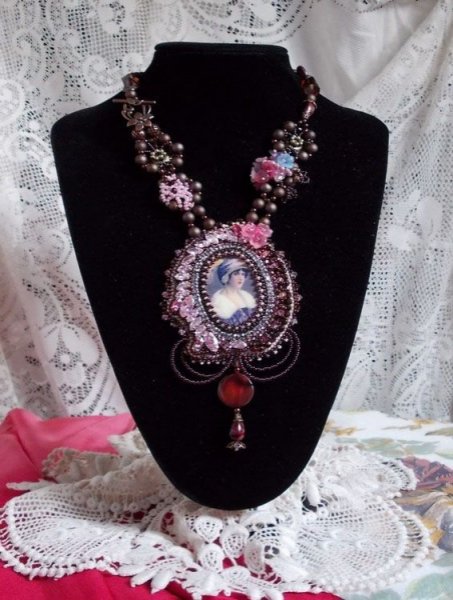 Collier Belle Romance Haute-Couture brodé avec un cabochon portrait de femme en chapeau avec des cristaux, des perles satinées, des perles rondes dorées, des perles nacrées, des cabochons en nacre et 