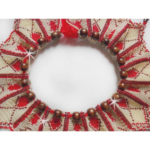 Collier Romane plastron mont&eacute; avec une abondance de rocailles aux couleurs : Bordeaux, Ivoire et Rouge &agrave; laquelle s'ajoute des gouttes plates, perles en bois, perles en laiton pour un style Ethnique