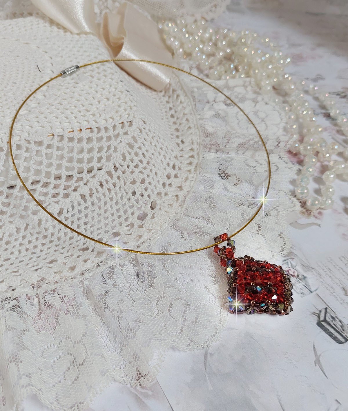 Pendentif Camel mont&eacute; avec des toupies en cristal Indian Red et Smoked Topaz de qualit&eacute; AB sur une base de facettes Dark Bronze et sur un tour de cou c&acirc;bl&eacute; rigide Dor&eacute; avec un fermoir &agrave; vis Argent&eacute;