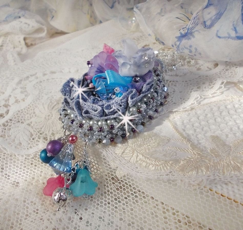 Pendentif Mademoiselle Bluse Haute-Couture brodé avec des Cristaux de Swarovski, des fleurs en résine, des perles nacrées, des rocailles et une chaîne en argent 925